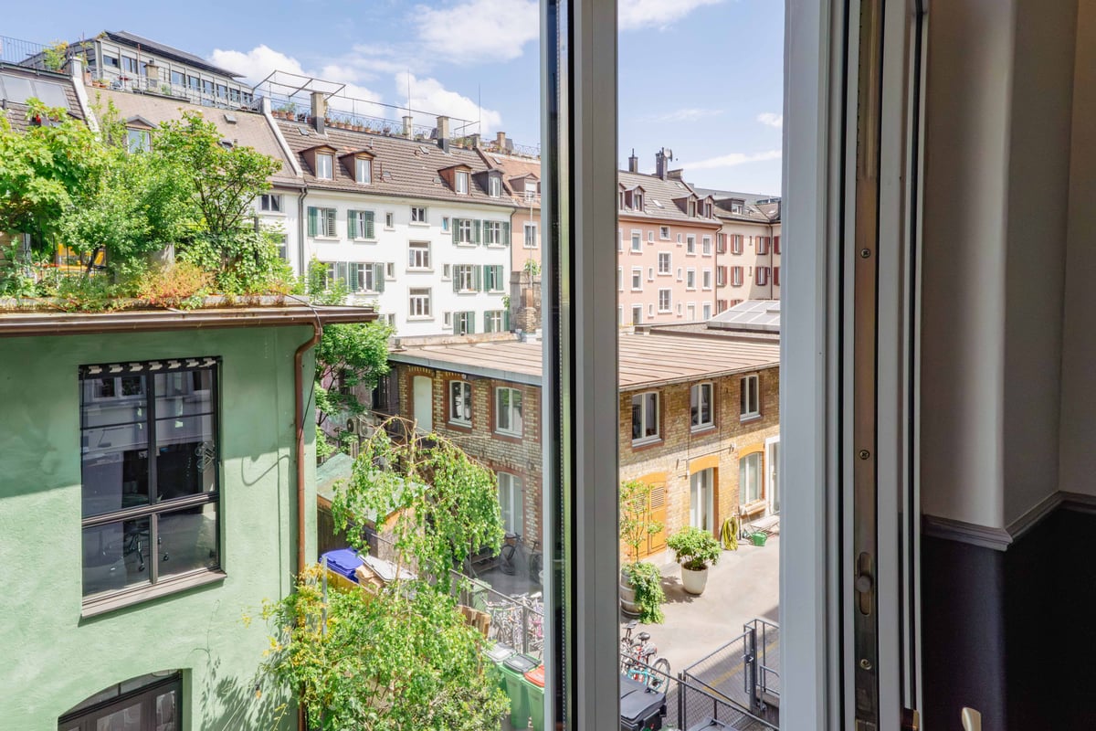 EasyHotel Zurich City Centre room view from window overlooking rooftops and buildings.