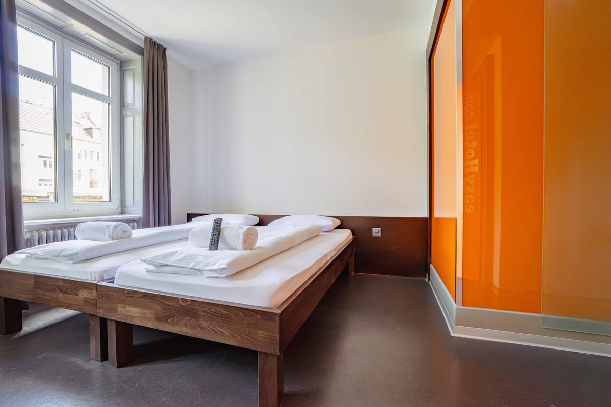 EasyHotel Zurich City Centre Twin Room with two single beds, white linens, and a window.