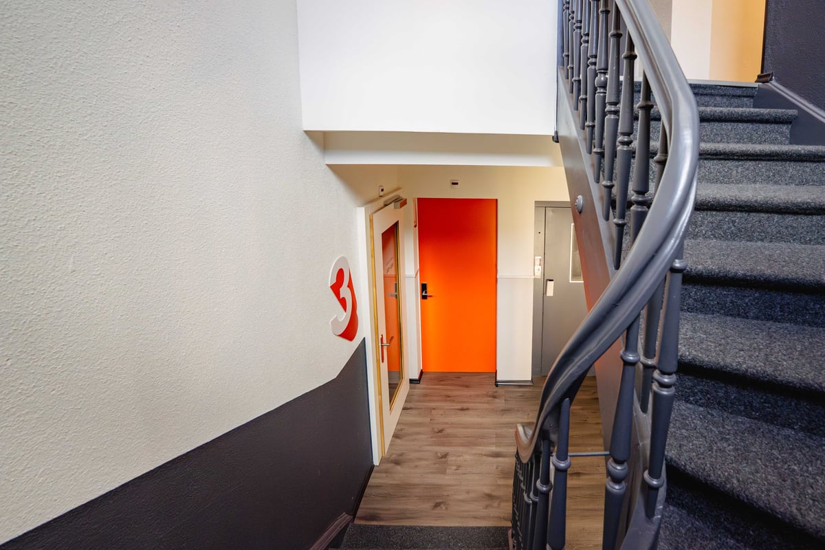 EasyHotel Zurich Main Station common area with a staircase and hallway leading to rooms.